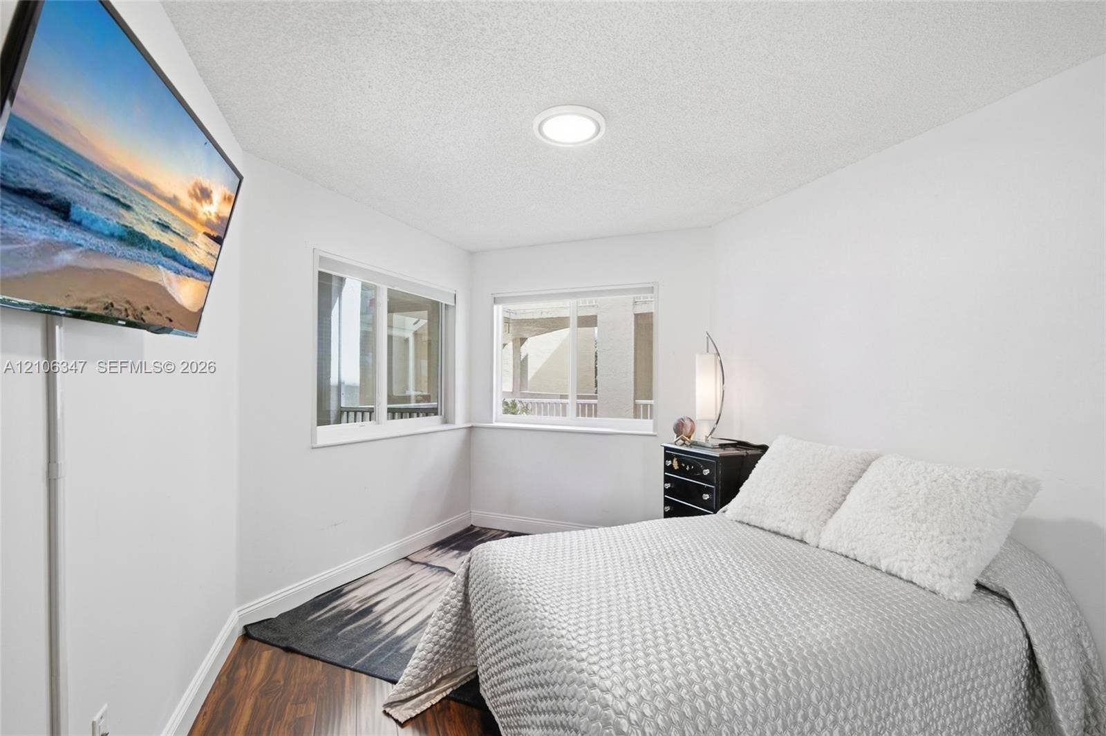 7759 Granville Drive, #306, Tamarac, FL 33321 Room featuring wood-finish flooring, dual windows, and recessed ceiling lighting