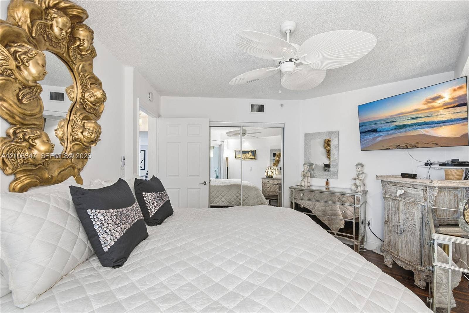 7759 Granville Drive, #306, Tamarac, FL 33321 Room featuring white wall finishes, a multi-blade ceiling fan, and mirrored sliding closet doors