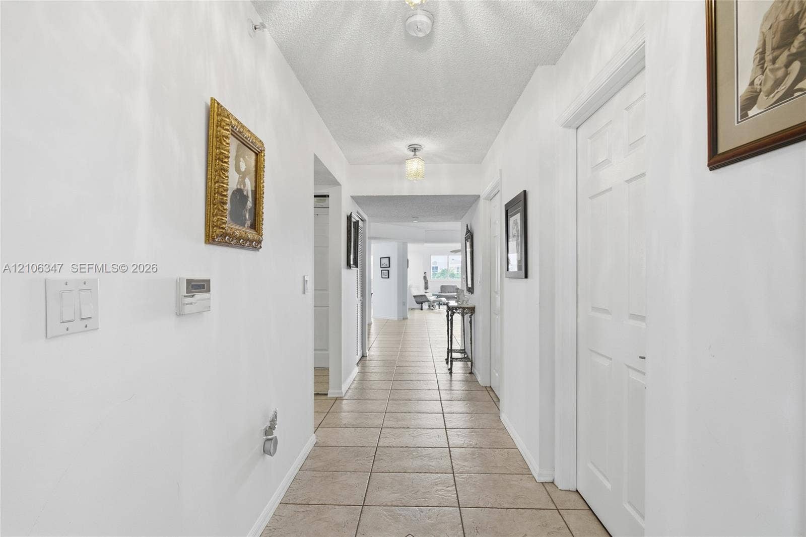 7759 Granville Drive, #306, Tamarac, FL 33321 Hallway featuring neutral tile flooring, smooth white walls, recessed lighting, and six-panel interior doors