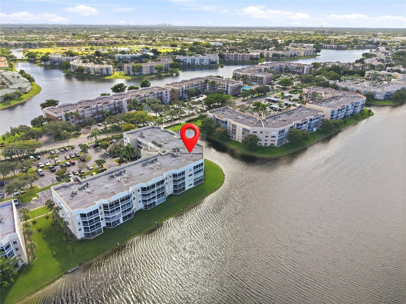 7759 Granville Drive, #306, Tamarac, FL 33321 Waterfront multi-story residential building situated on a peninsula with panoramic canal water frontage and established landscaping