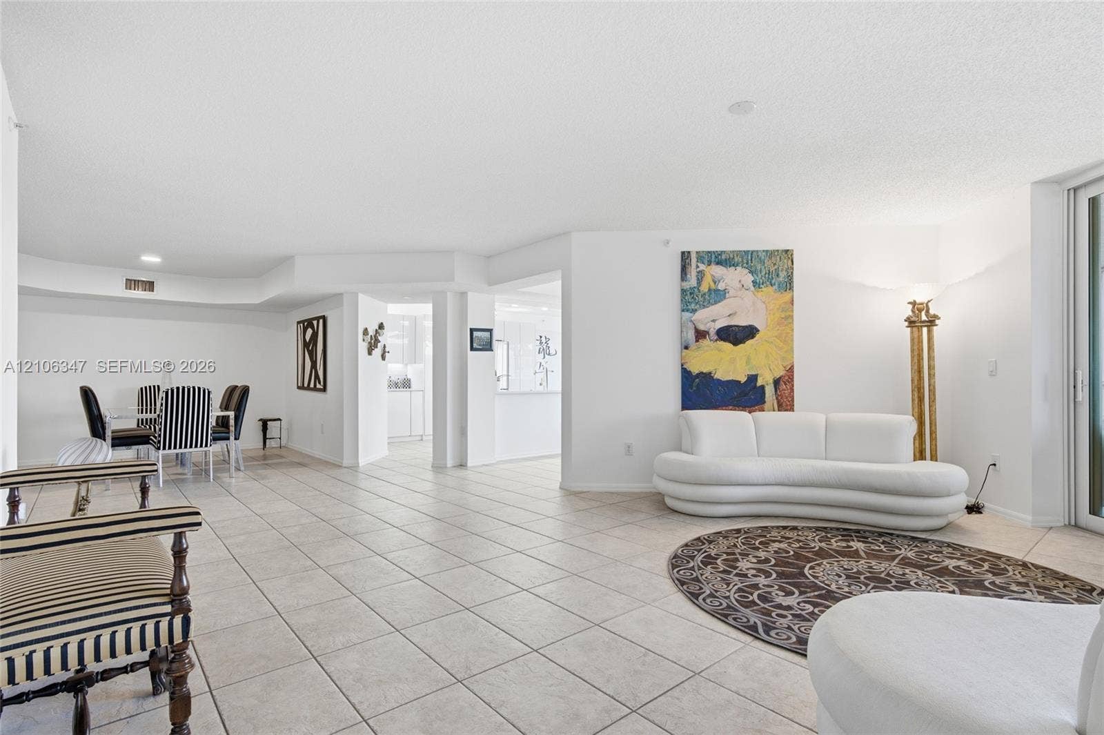 7759 Granville Drive, #306, Tamarac, FL 33321 Open-concept interior featuring large-format ceramic tile flooring, recessed lighting, and sliding glass doors