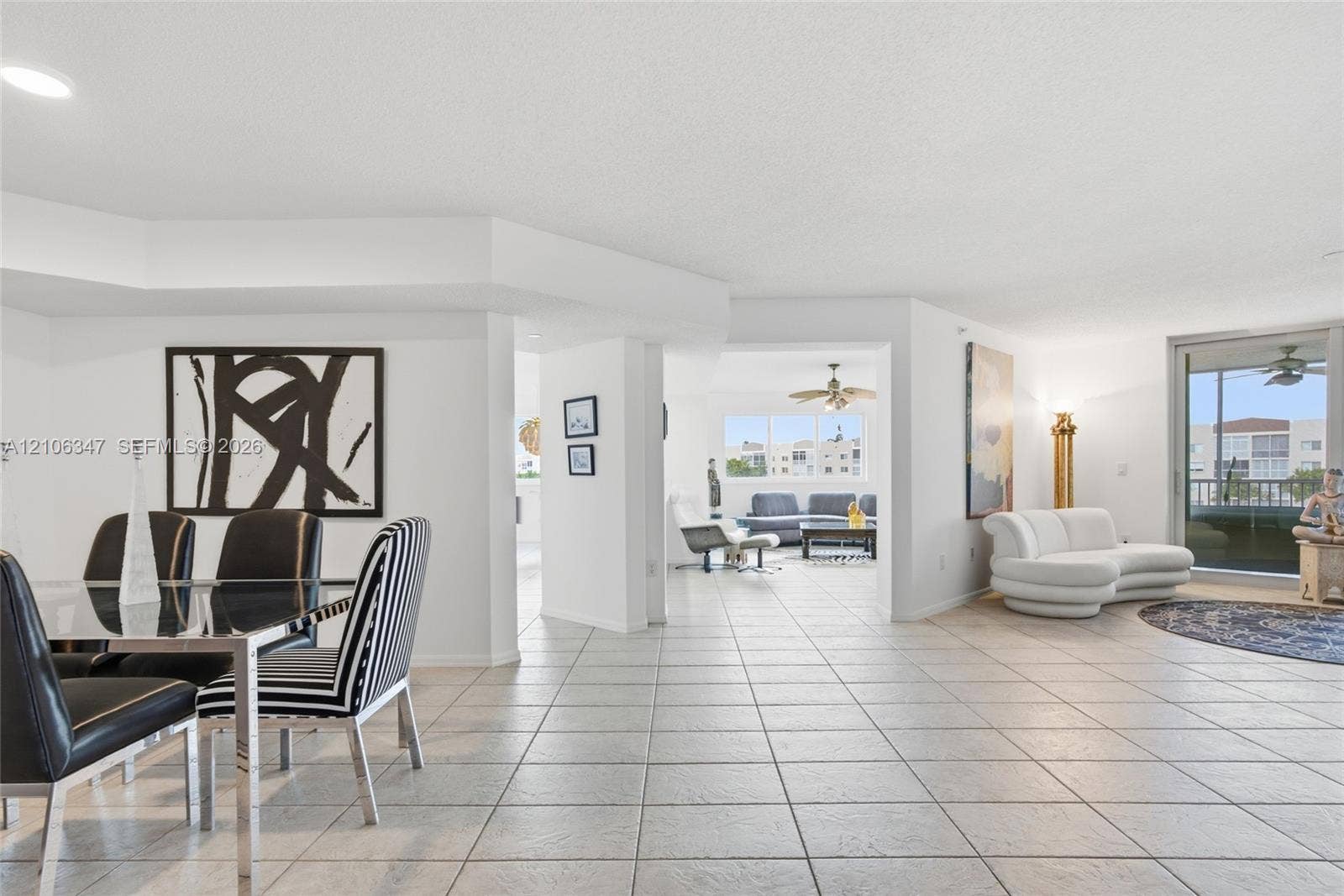 7759 Granville Drive, #306, Tamarac, FL 33321 Neutral ceramic tile flooring, recessed lighting, and sliding glass balcony doors