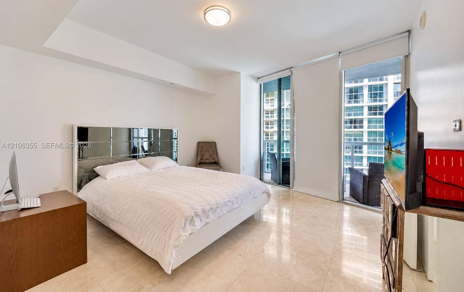 495 Brickell Avenue, #1906, Miami, Miami, FL 33131 Light-filled room featuring large-format tile flooring, recessed ceiling lighting, and floor-to-ceiling glass sliding doors providing external access