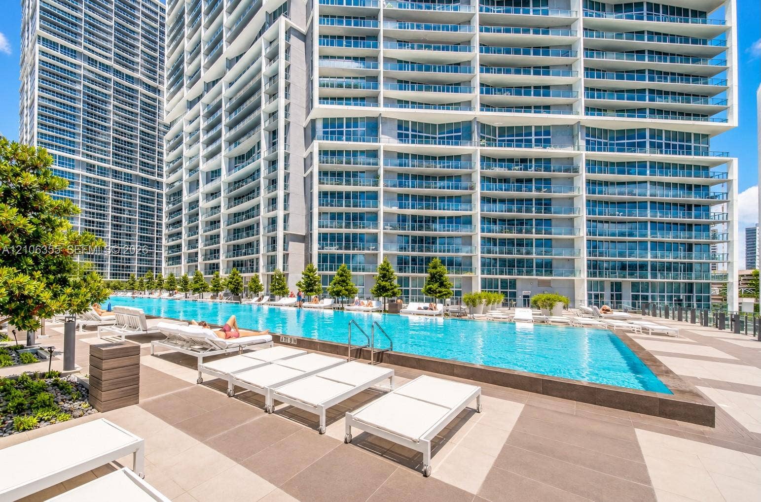 495 Brickell Avenue, #1906, Miami, Miami, FL 33131 Infinity-edge swimming pool featuring a tiled deck, concrete surround, and structured landscaping