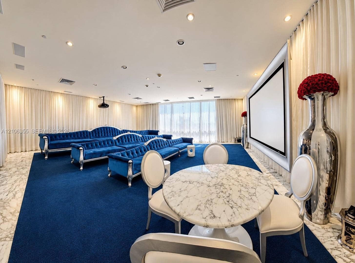 495 Brickell Avenue, #1906, Miami, Miami, FL 33131 Media room featuring a wall-mounted projection screen, recessed ceiling lighting, wall-to-wall carpeting, and natural stone flooring perimeter