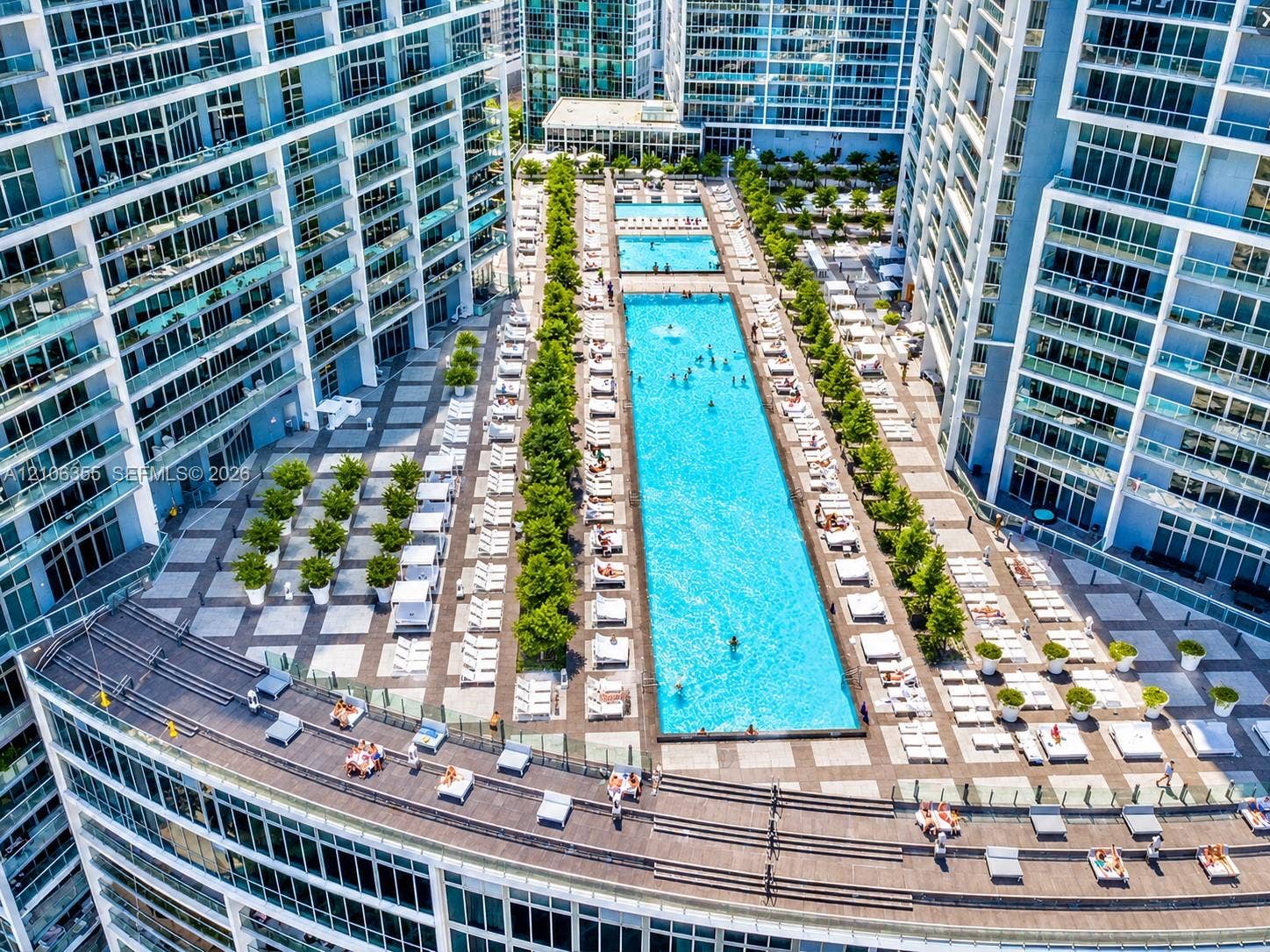 495 Brickell Avenue, #1906, Miami, Miami, FL 33131 Elevated terrace featuring a rectangular swimming pool, integrated landscaping, and expansive tiled deck space