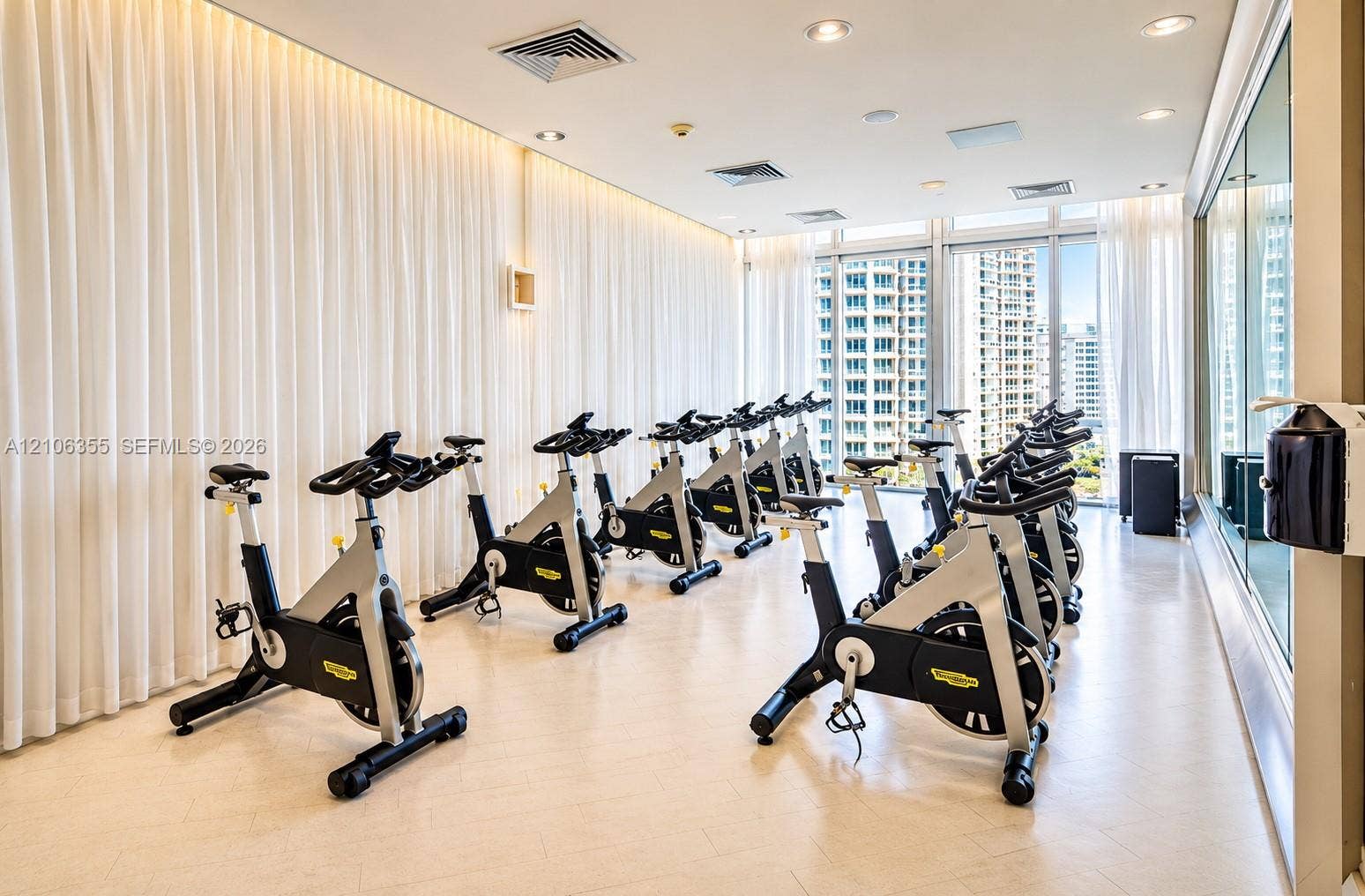 495 Brickell Avenue, #1906, Miami, Miami, FL 33131 Fitness center featuring floor-to-ceiling windows, recessed lighting, expansive wall mirrors, and light-toned hard-surface flooring