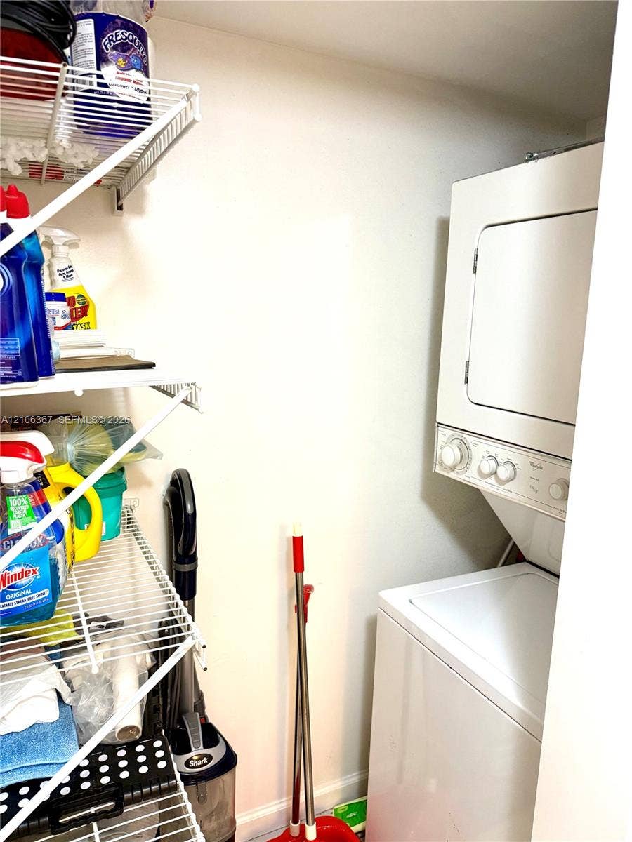 Stackable laundry unit featuring white appliance finish and integrated multi-tier wire shelving