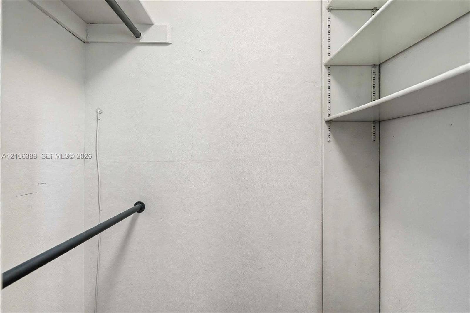 8110 SW 82nd Court, Miami, FL 33143 Storage area featuring adjustable shelving units, a horizontal hanging rod, and an overhead shelf