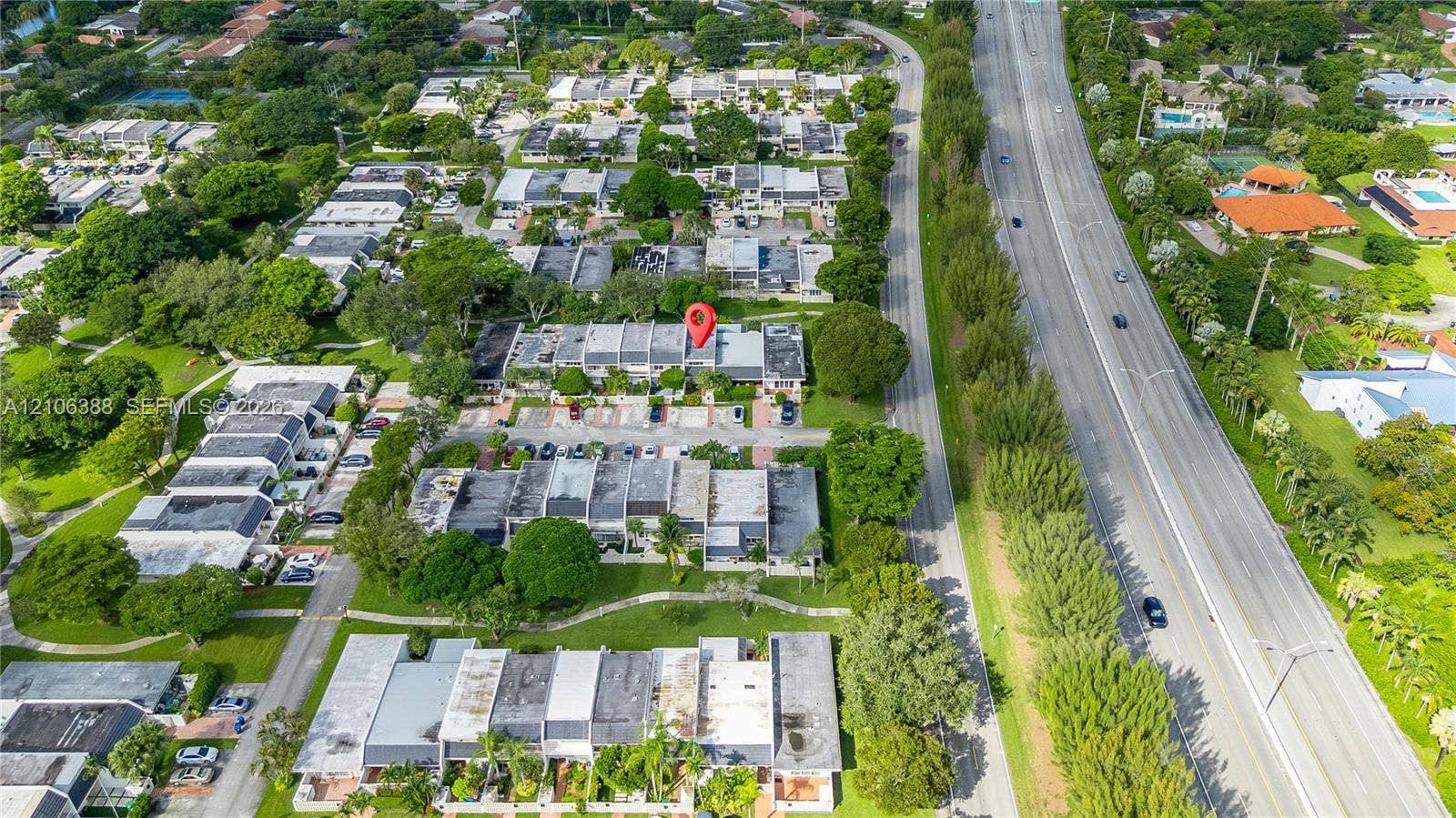 8110 SW 82nd Court, Miami, FL 33143 Aerial perspective featuring multi-unit residential structures, paved parking areas, and mature tree canopy throughout the grounds