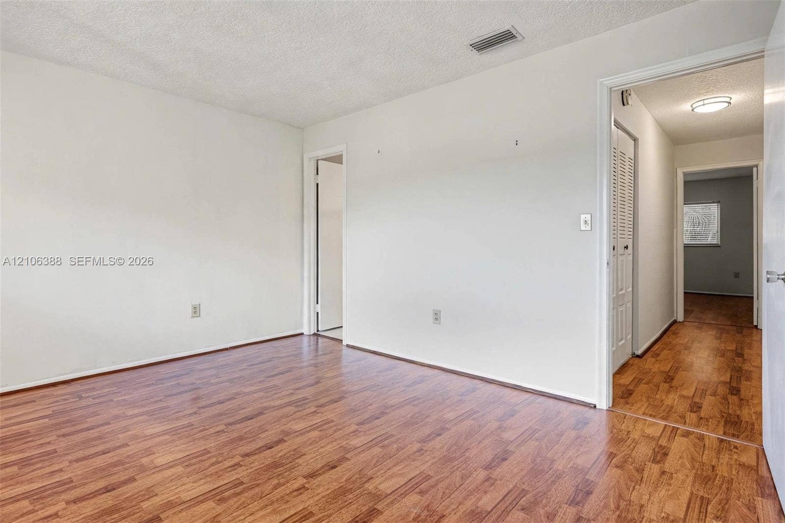 8110 SW 82nd Court, Miami, FL 33143 Interior space featuring wood-finish flooring, white walls, and a white bi-fold door closet
