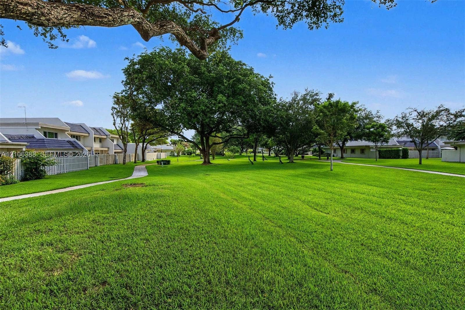 8110 SW 82nd Court, Miami, FL 33143 Expansive lawn featuring mature trees and paved walkways