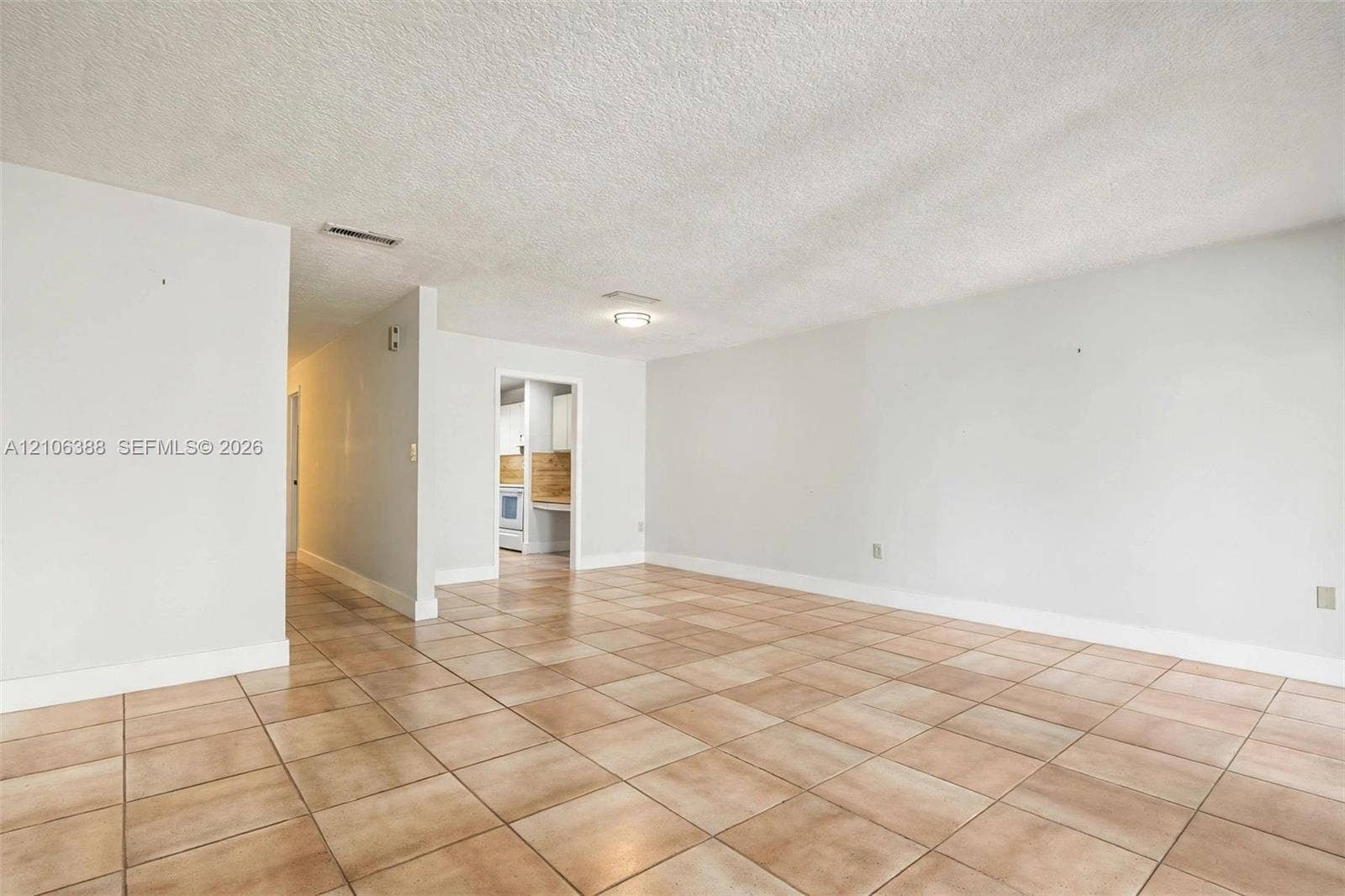 8110 SW 82nd Court, Miami, FL 33143 Open-concept living space featuring large-format ceramic tile flooring, neutral wall tones, and overhead flush-mount lighting