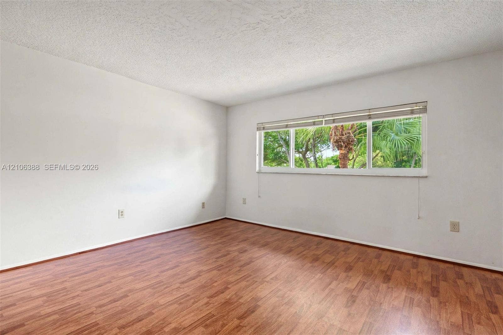 8110 SW 82nd Court, Miami, FL 33143 Room featuring wood-finish flooring, white walls, and a large horizontal window with blinds