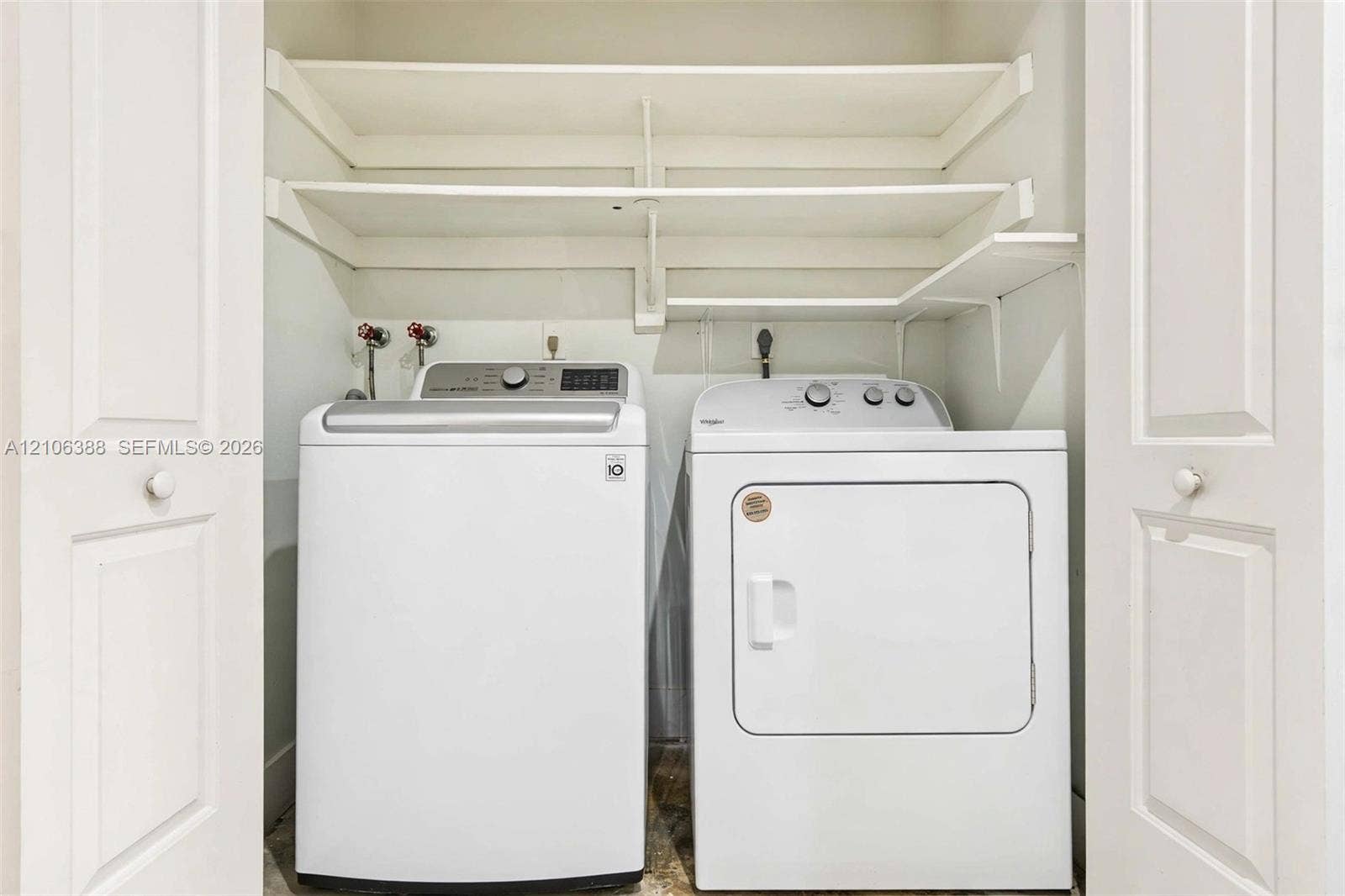 8110 SW 82nd Court, Miami, FL 33143 Laundry closet featuring white bifold doors and integrated tiered shelving