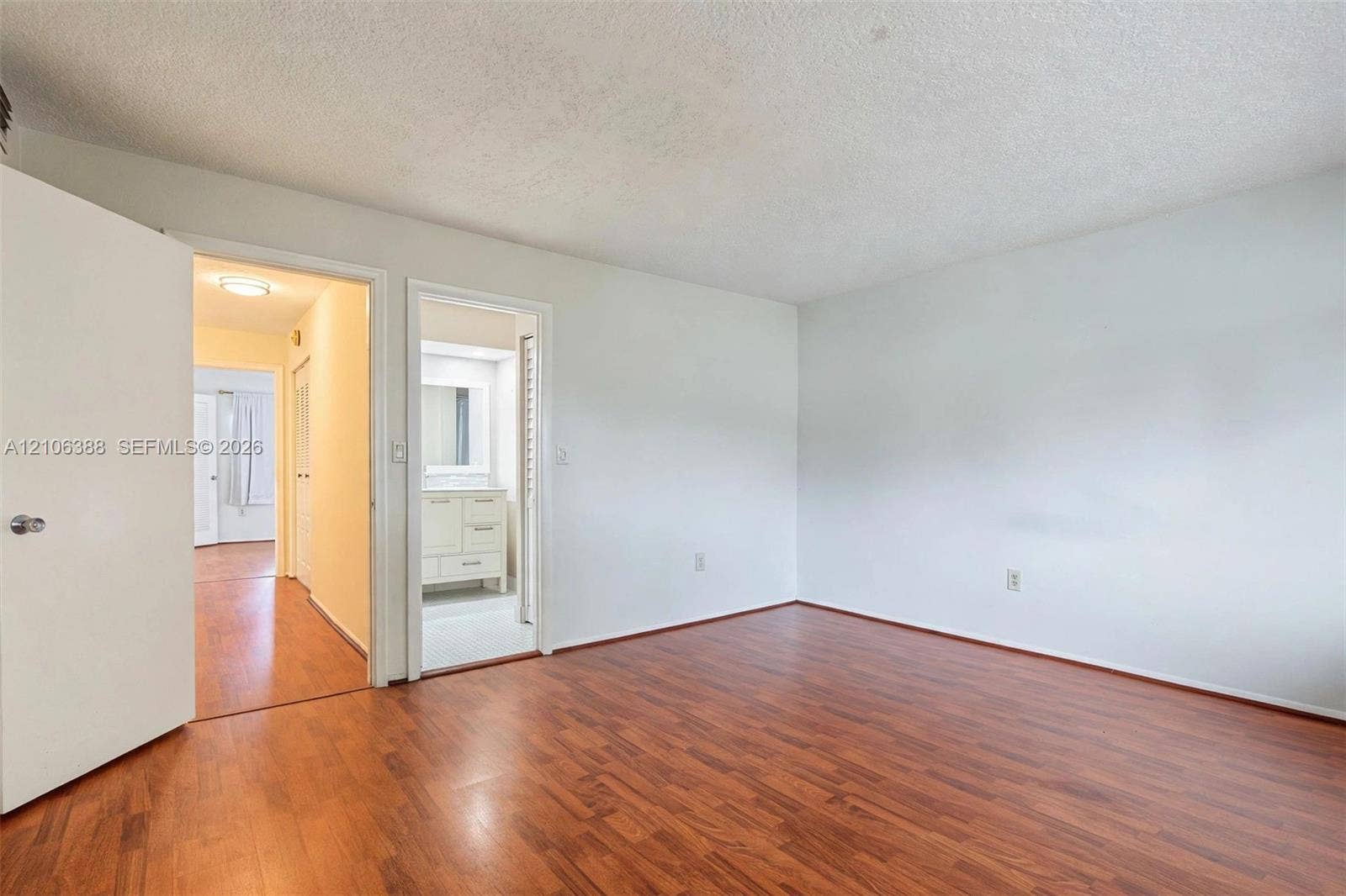 8110 SW 82nd Court, Miami, FL 33143 Room featuring wood-finish flooring, neutral walls, and solid-core interior doors