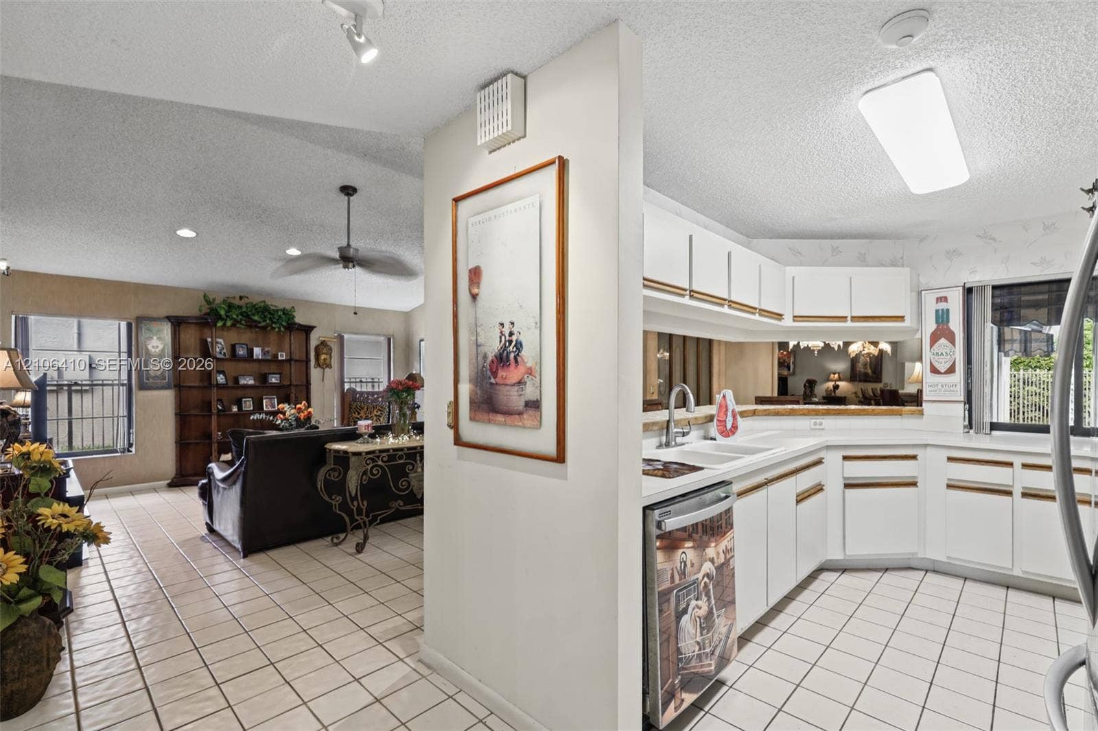 1725 Lakeshore Circle, Weston, FL 33326 Kitchen featuring white cabinetry, ceramic tile flooring, and integrated lighting