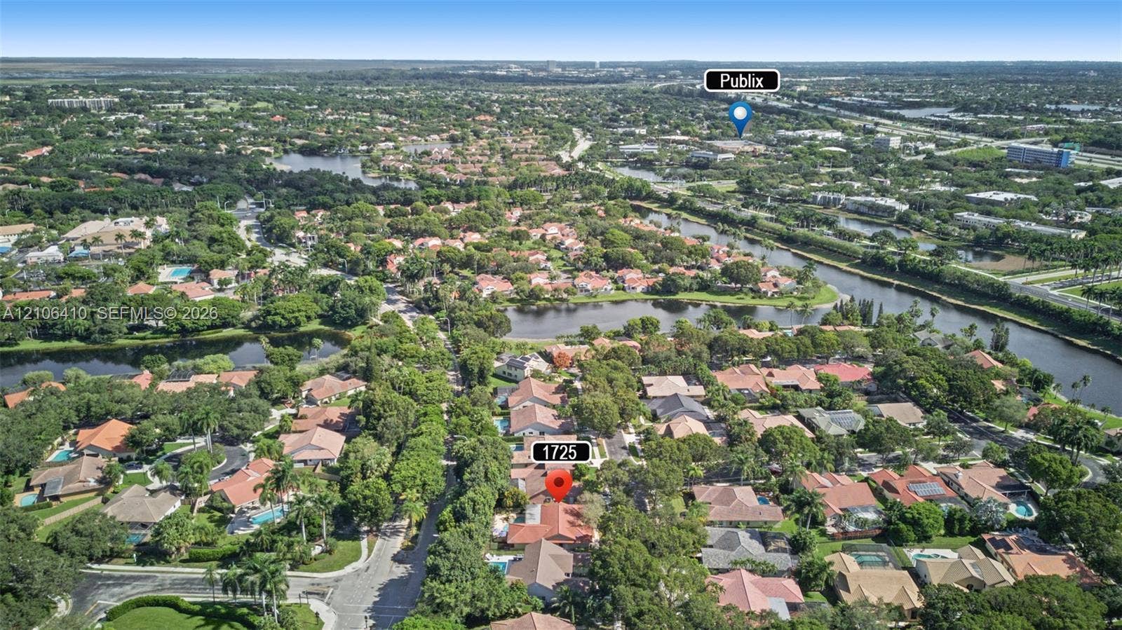 1725 Lakeshore Circle, Weston, FL 33326 Aerial perspective highlighting mature tree canopy, neighborhood lakes, and established residential landscaping