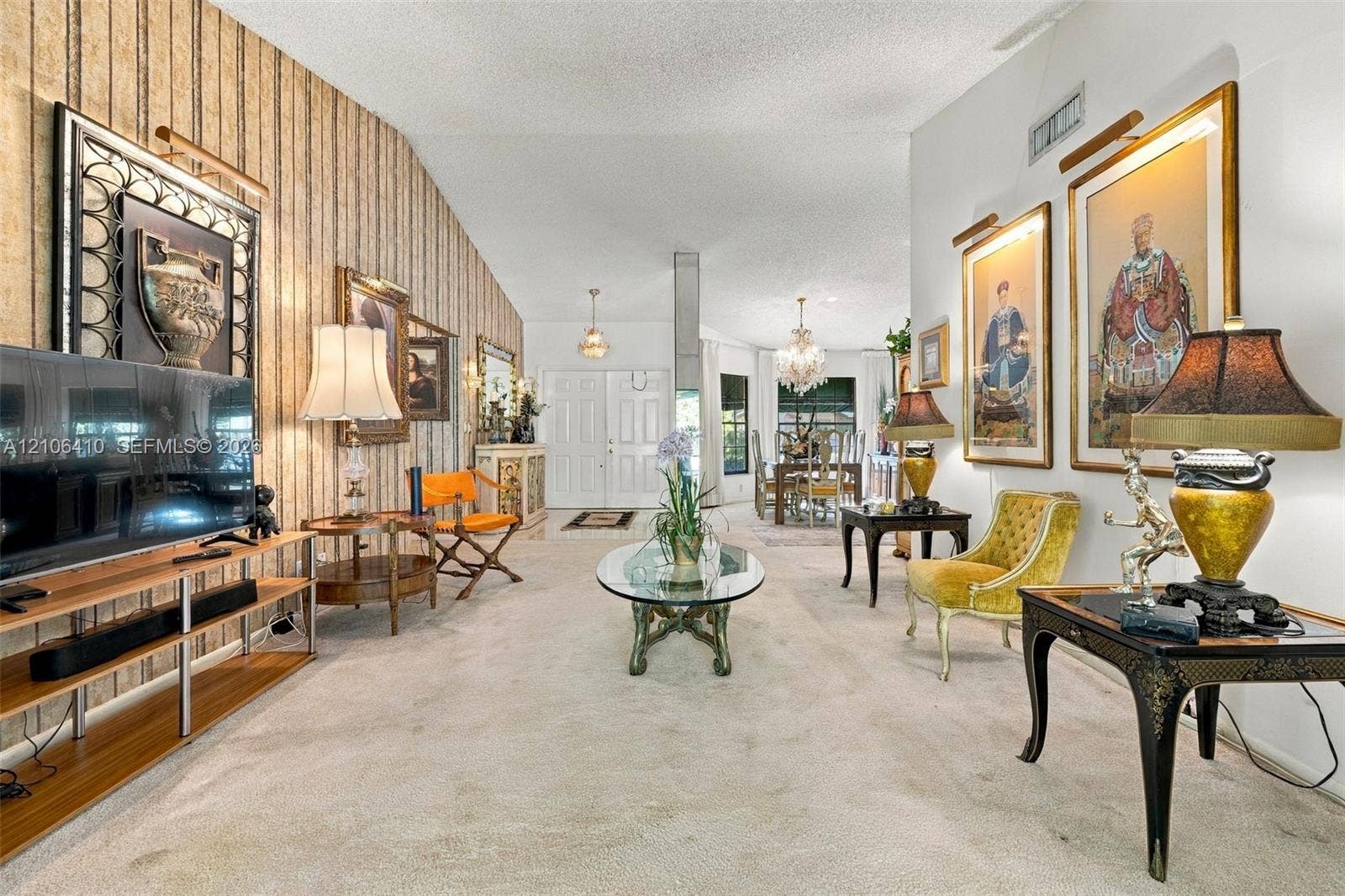1725 Lakeshore Circle, Weston, FL 33326 Vaulted ceilings, textured wall treatment, and multiple wall-mounted picture lights