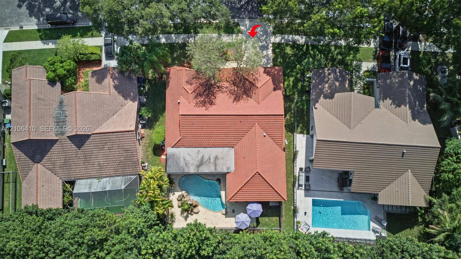 1725 Lakeshore Circle, Weston, FL 33326 Aerial perspective of property featuring a tile roof, an in-ground swimming pool, and hardscaped patio area