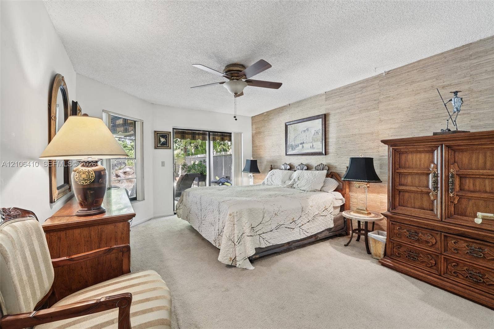 1725 Lakeshore Circle, Weston, FL 33326 Textured wall covering, sliding glass door, ceiling fan, and window