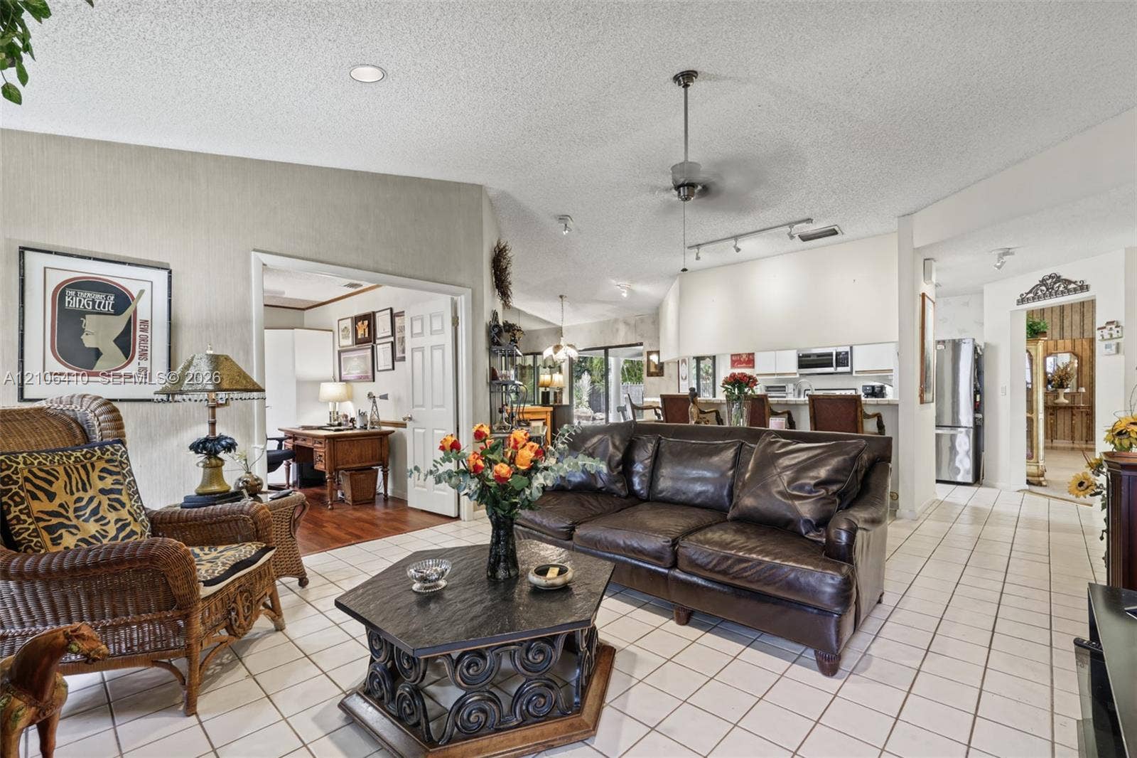 1725 Lakeshore Circle, Weston, FL 33326 Open-concept living space featuring vaulted ceilings, ceramic tile flooring, a ceiling fan, and recessed lighting