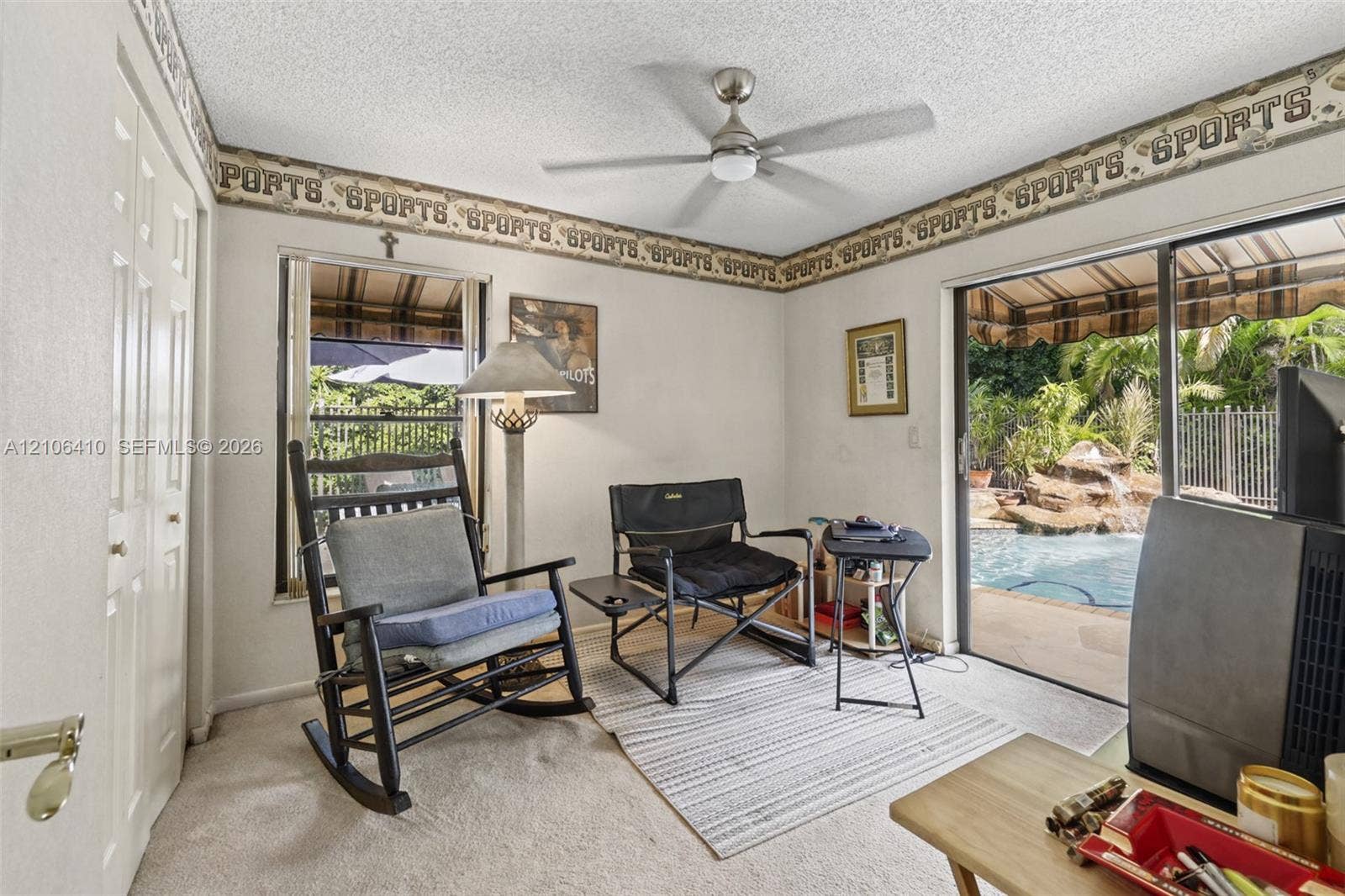 1725 Lakeshore Circle, Weston, FL 33326 Interior space featuring a ceiling fan, sliding glass door, and dual-panel closet door