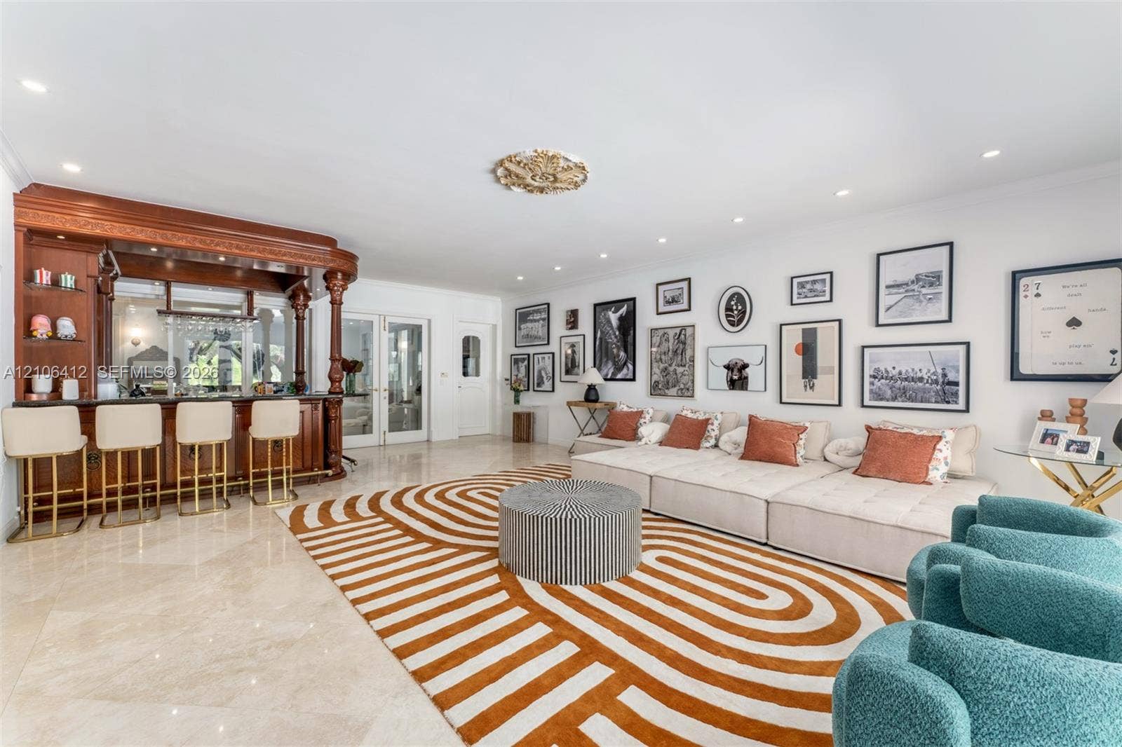 Living area featuring stone flooring, recessed lighting, ceiling medallion, and custom built-in wooden bar cabinetry