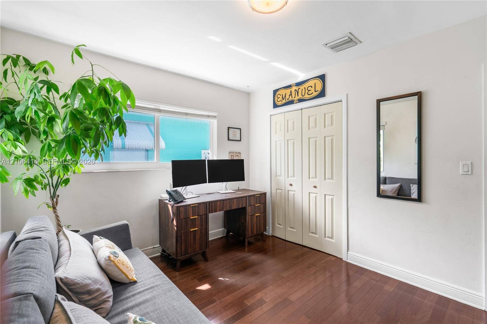 9133 Garland Avenue, Surfside, FL 33154 Wood-finish flooring, dual-panel closet doors, and natural light via horizontal windows