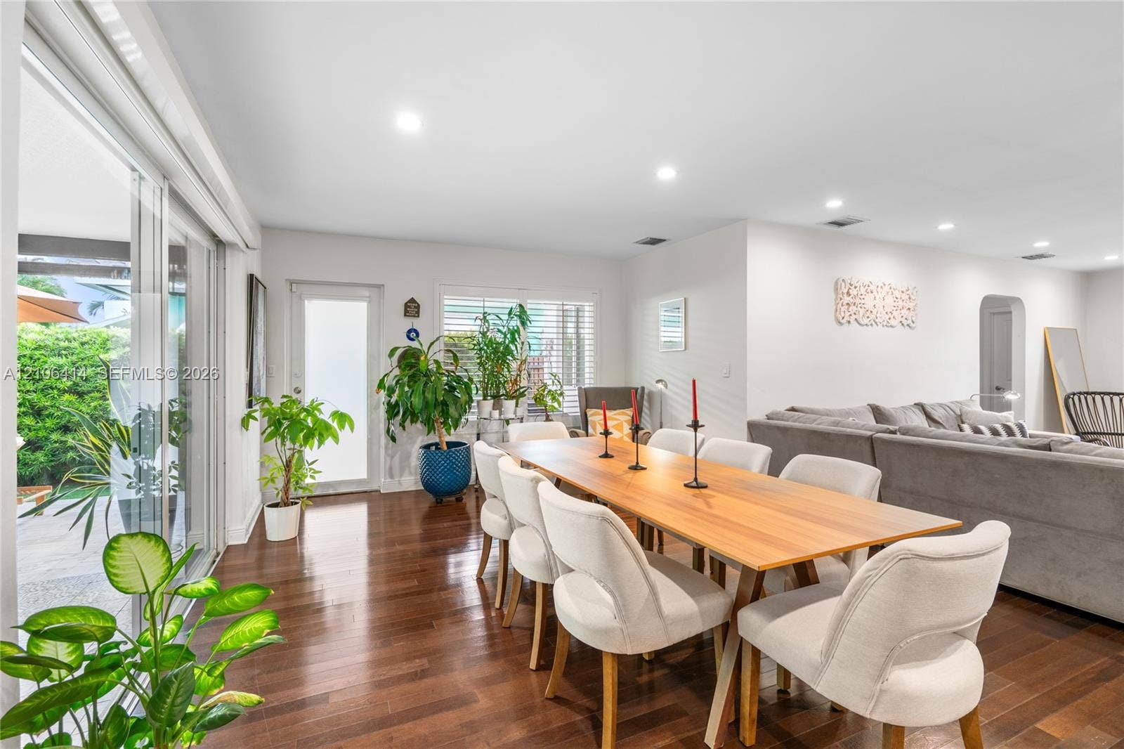 9133 Garland Avenue, Surfside, FL 33154 Interior space featuring wood-finish flooring, recessed lighting, expansive sliding glass doors, and a glass-paneled exterior door