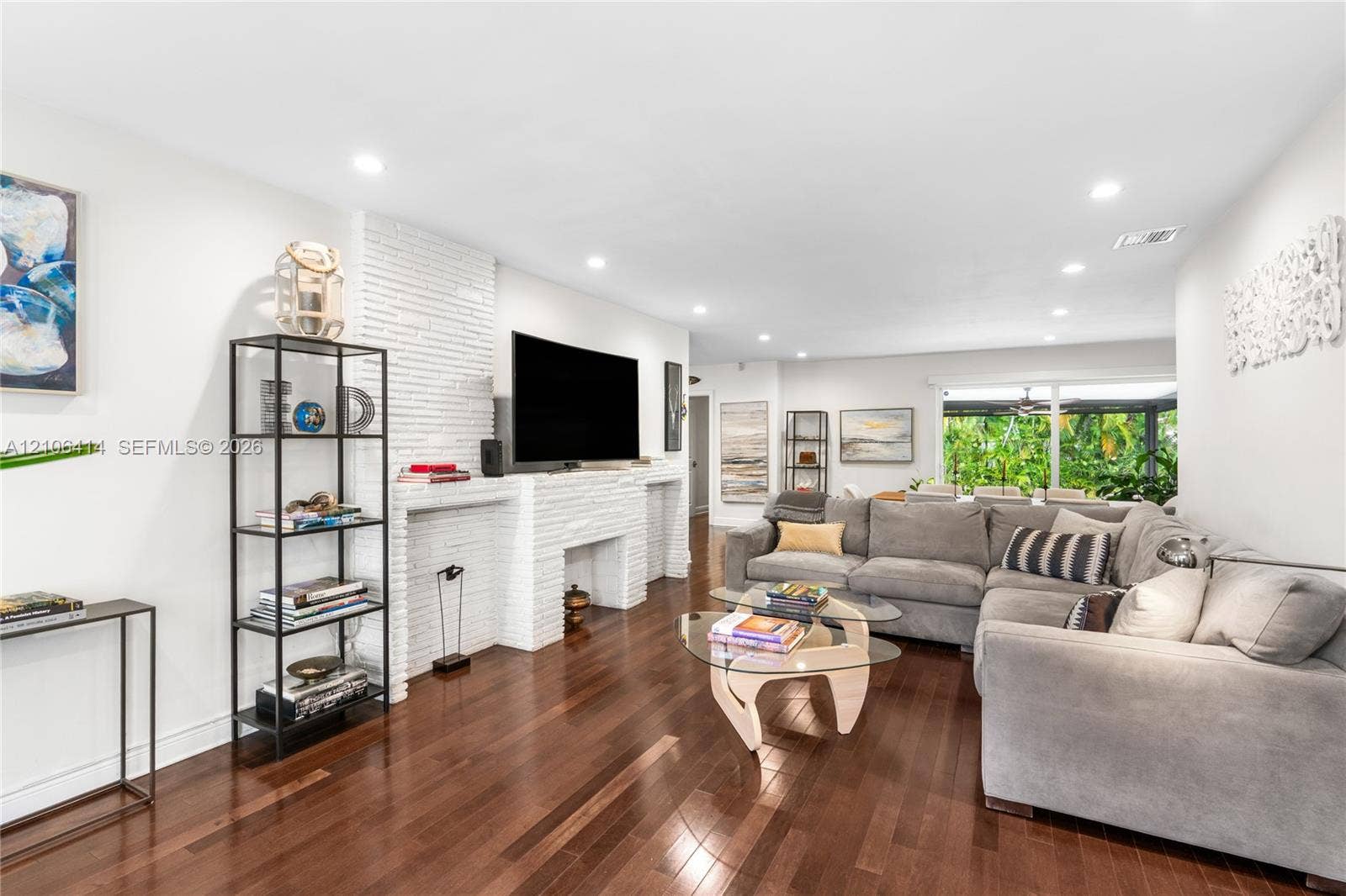 9133 Garland Avenue, Surfside, FL 33154 Living area featuring wood-finish flooring, recessed lighting, and a floor-to-ceiling white brick fireplace