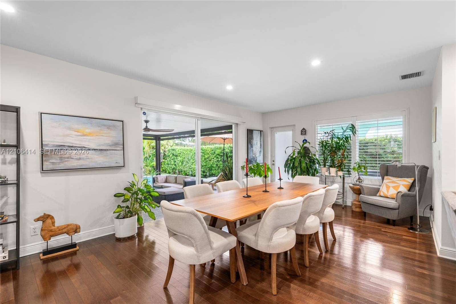 9133 Garland Avenue, Surfside, FL 33154 Dining area featuring dark wood-finish flooring, recessed lighting, and large sliding glass doors providing access to the exterior