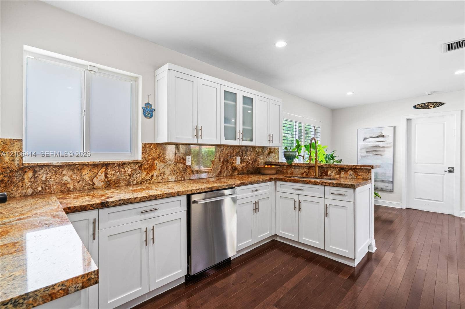 9133 Garland Avenue, Surfside, FL 33154 Kitchen featuring white cabinetry with glass-front uppers, stone countertops, stone backsplash, stainless steel dishwasher, and wood-finish flooring