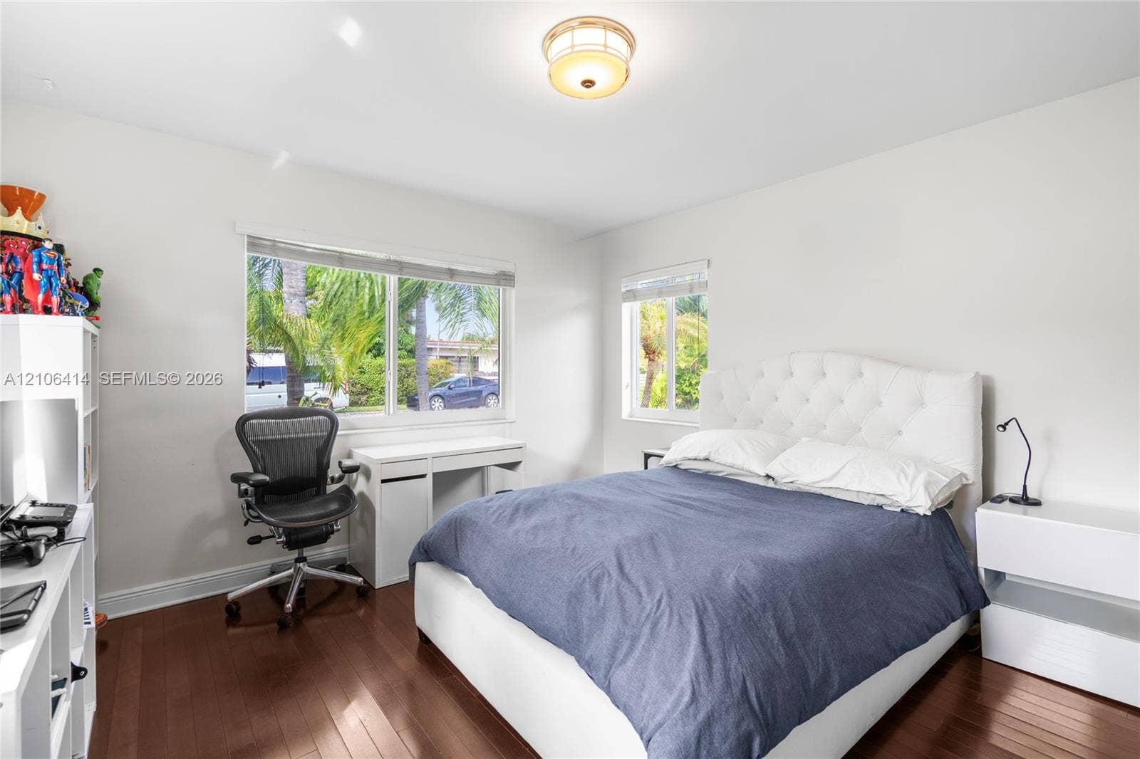 9133 Garland Avenue, Surfside, FL 33154 Bedroom featuring dark wood-finish flooring, dual windows, and a flush-mount ceiling light fixture