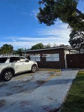 5712 Hollywood Boulevard, #3, Hollywood, Hollywood, FL 33021 Exterior facade featuring brown brick masonry, horizontal sliding windows, and an attached privacy gate