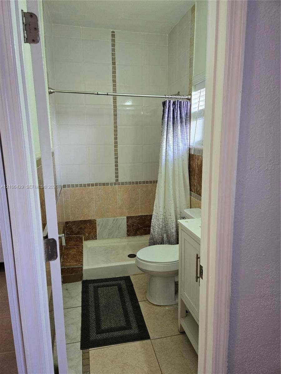 5712 Hollywood Boulevard, #3, Hollywood, Hollywood, FL 33021 Bathroom featuring a standing shower with tiled surround, neutral-toned tile flooring, and a white vanity cabinet