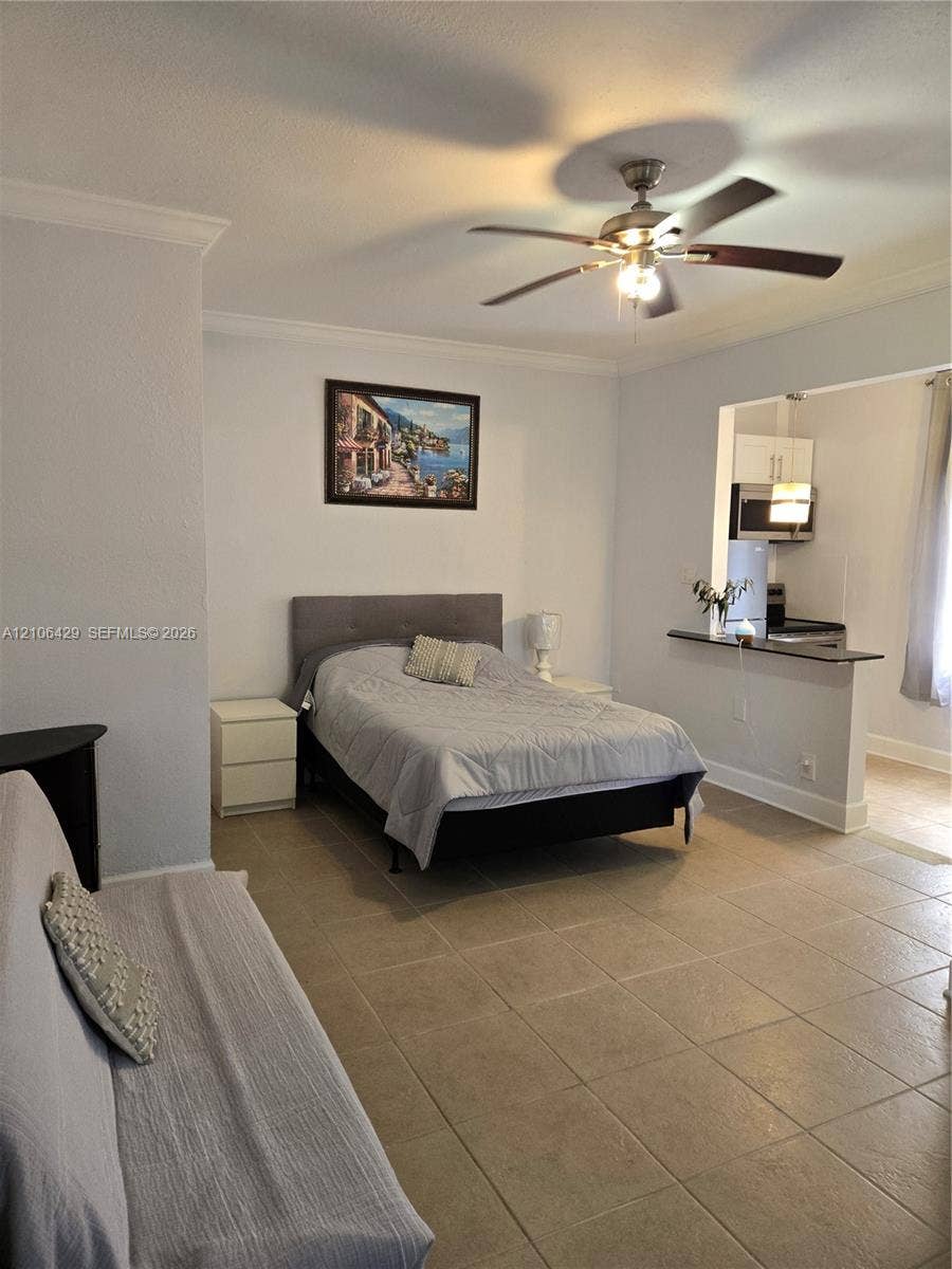 5712 Hollywood Boulevard, #3, Hollywood, Hollywood, FL 33021 Ceramic tile flooring, crown molding, and ceiling fan with integrated lighting fixture