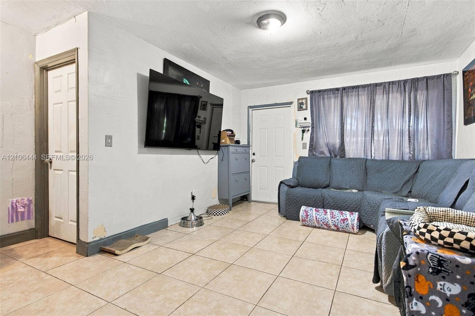 Ceramic tile flooring, white interior doors, and a ceiling-mounted light fixture