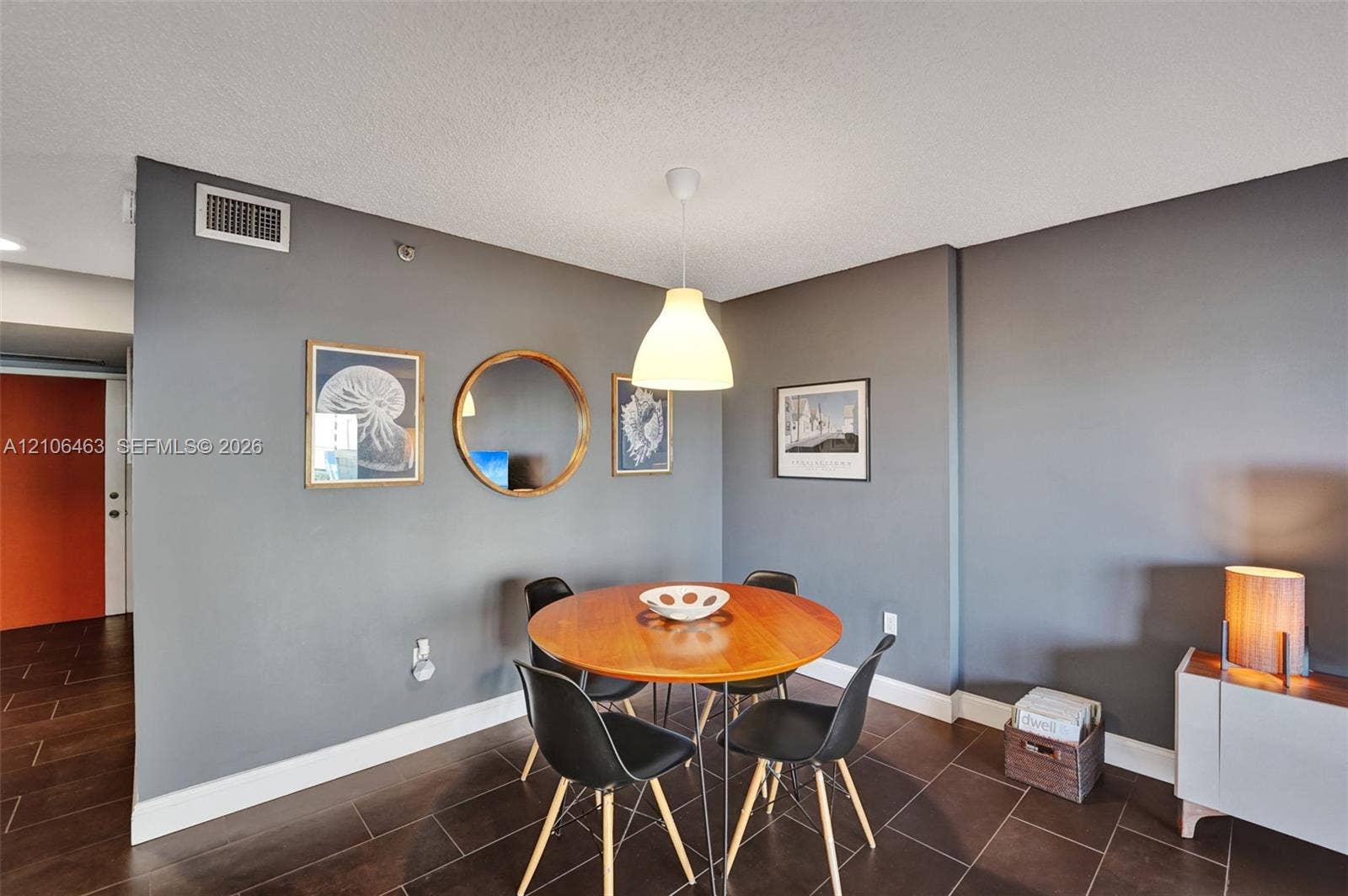 1201 S Ocean Drive, #218N, Hollywood, FL 33019 Interior space featuring charcoal-toned walls, large-format tile flooring, and a suspended white pendant light fixture
