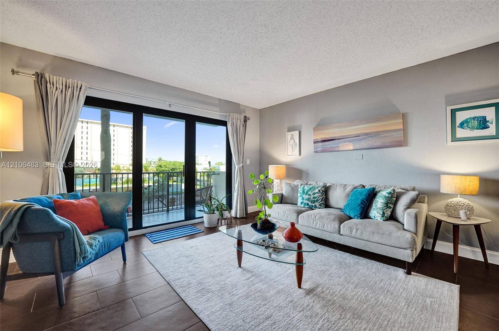 1201 S Ocean Drive, #218N, Hollywood, FL 33019 Living area featuring large-format tile flooring and expansive sliding glass doors opening to a private balcony