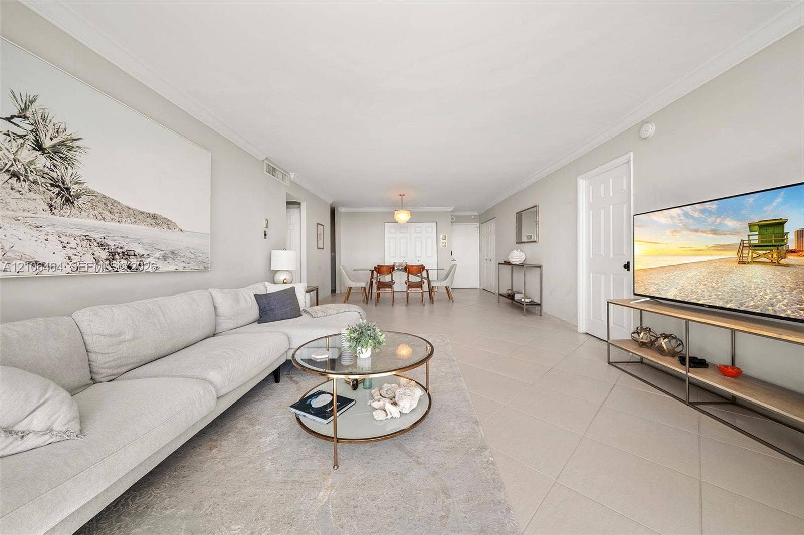 6770 Indian Creek Drive, #8E, Miami Beach, FL 33141 Open-concept interior featuring large-format neutral floor tile, crown molding, and recessed lighting