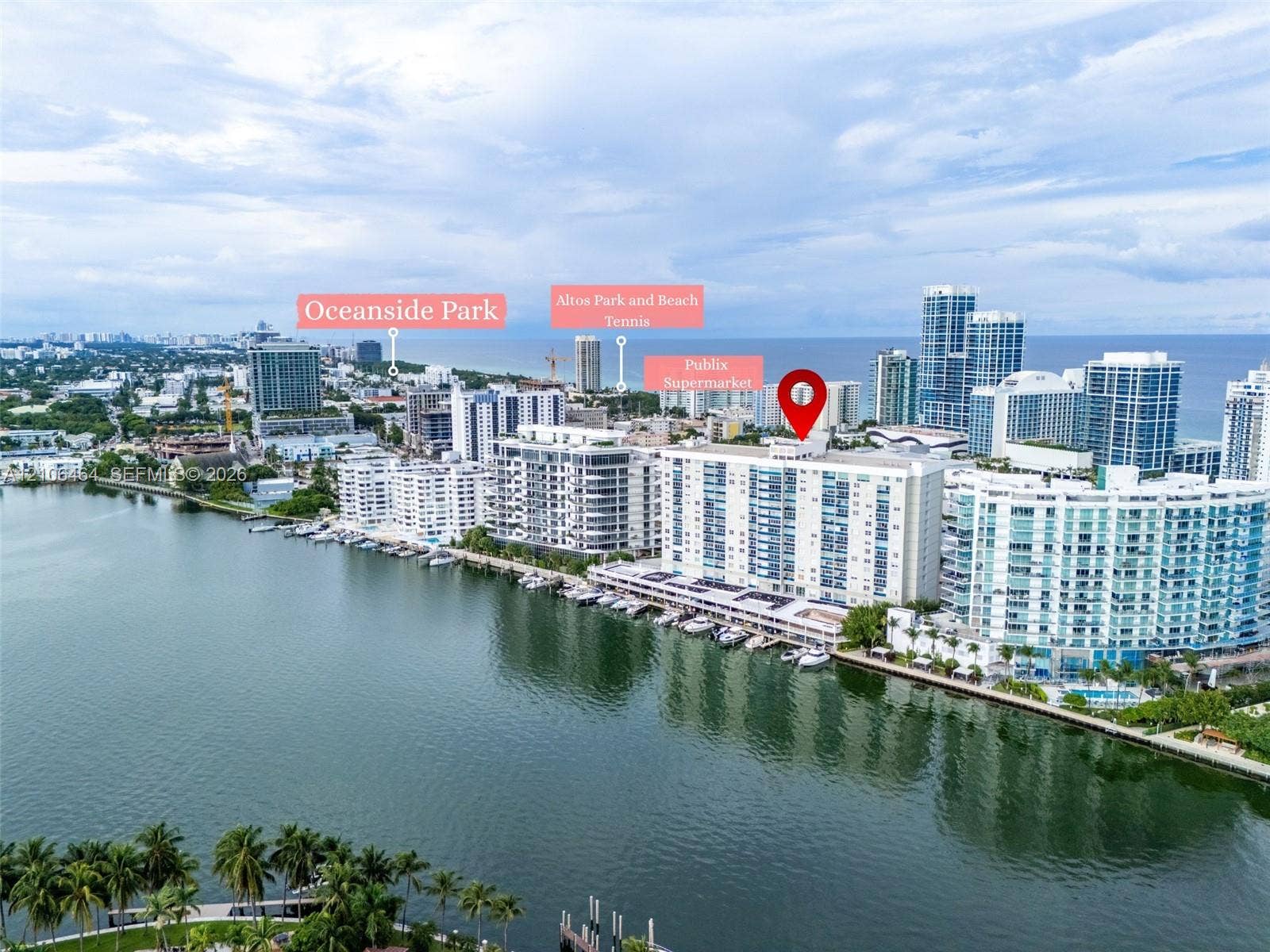 Aerial perspective of a high-rise waterfront condominium complex featuring a deep-water marina, direct access to the Intracoastal Waterway, and proximity to regional parks and coastal recreation areas