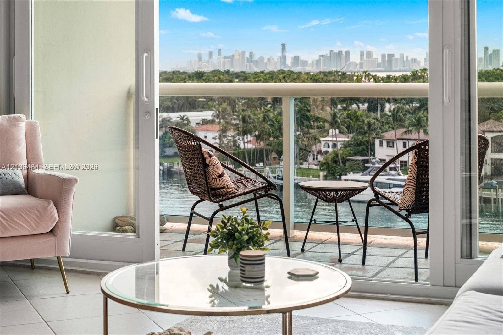 6770 Indian Creek Drive, #8E, Miami Beach, FL 33141 Balcony featuring glass railings, tile flooring, and direct exterior access via sliding glass doors