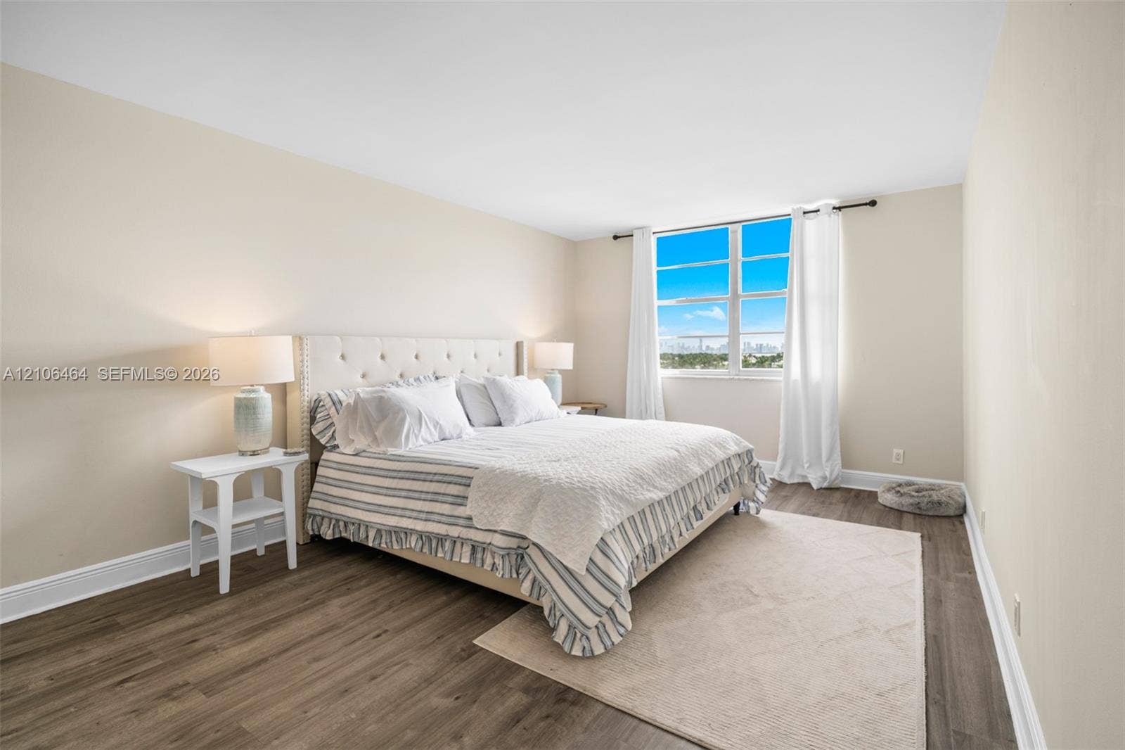 6770 Indian Creek Drive, #8E, Miami Beach, FL 33141 Neutral-toned bedroom featuring wood-finish flooring and large windows with natural lighting