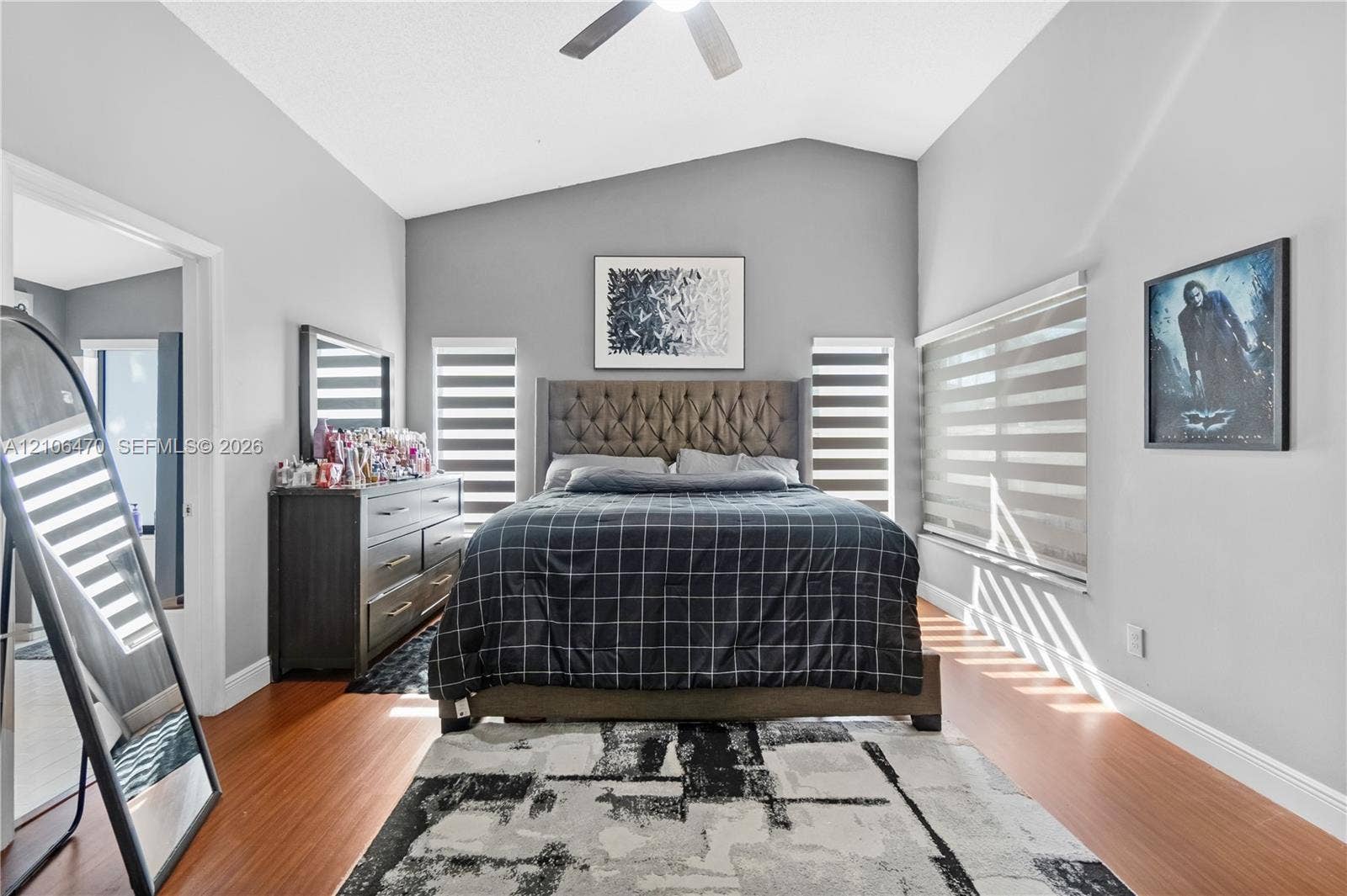 Vaulted ceilings, wood-finish flooring, and multi-paneled windows with integrated blinds