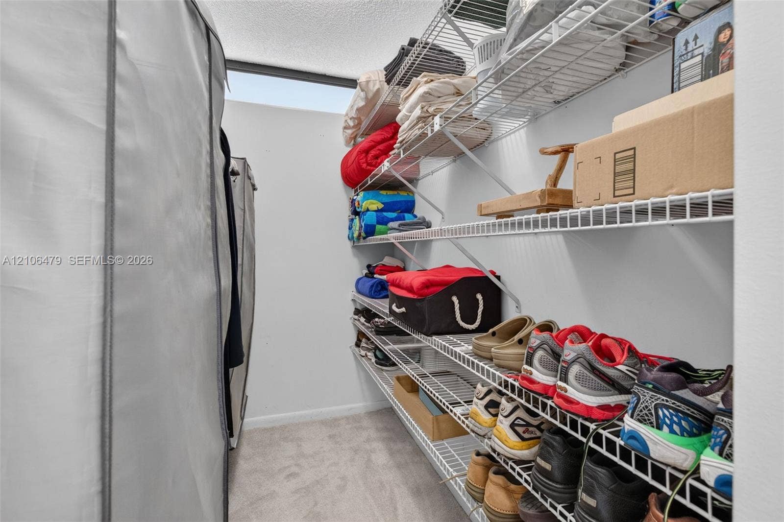 2800 SW 87th Avenue, #1113, Davie, FL 33328 Storage area featuring wall-to-wall wire shelving and carpeted flooring