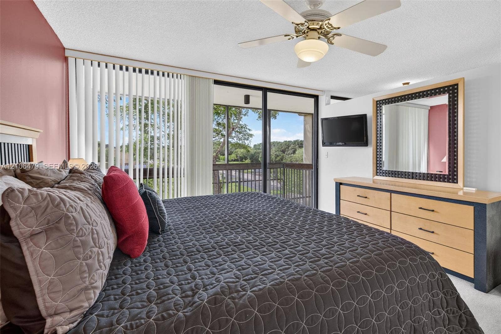 2800 SW 87th Avenue, #1113, Davie, FL 33328 Sliding glass doors with vertical blinds, ceiling fan with light fixture, and outdoor balcony access