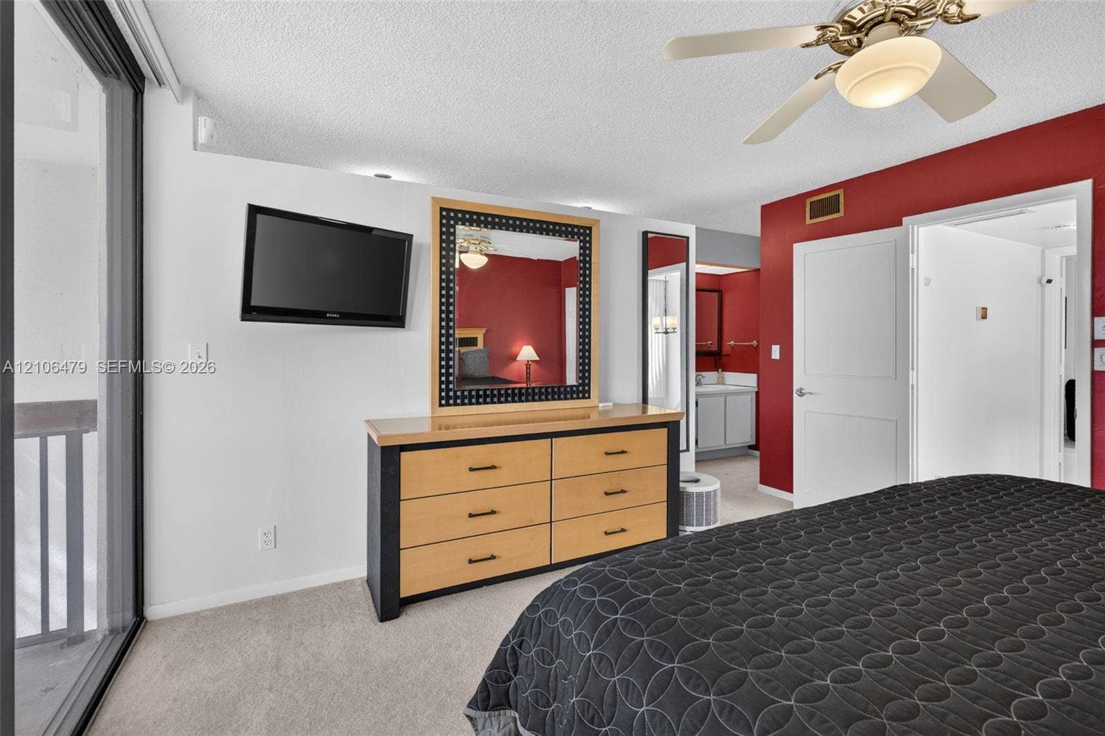2800 SW 87th Avenue, #1113, Davie, FL 33328 Wall-to-wall carpeting, ceiling fan with integrated lighting, glass sliding door, and neutral wall tones