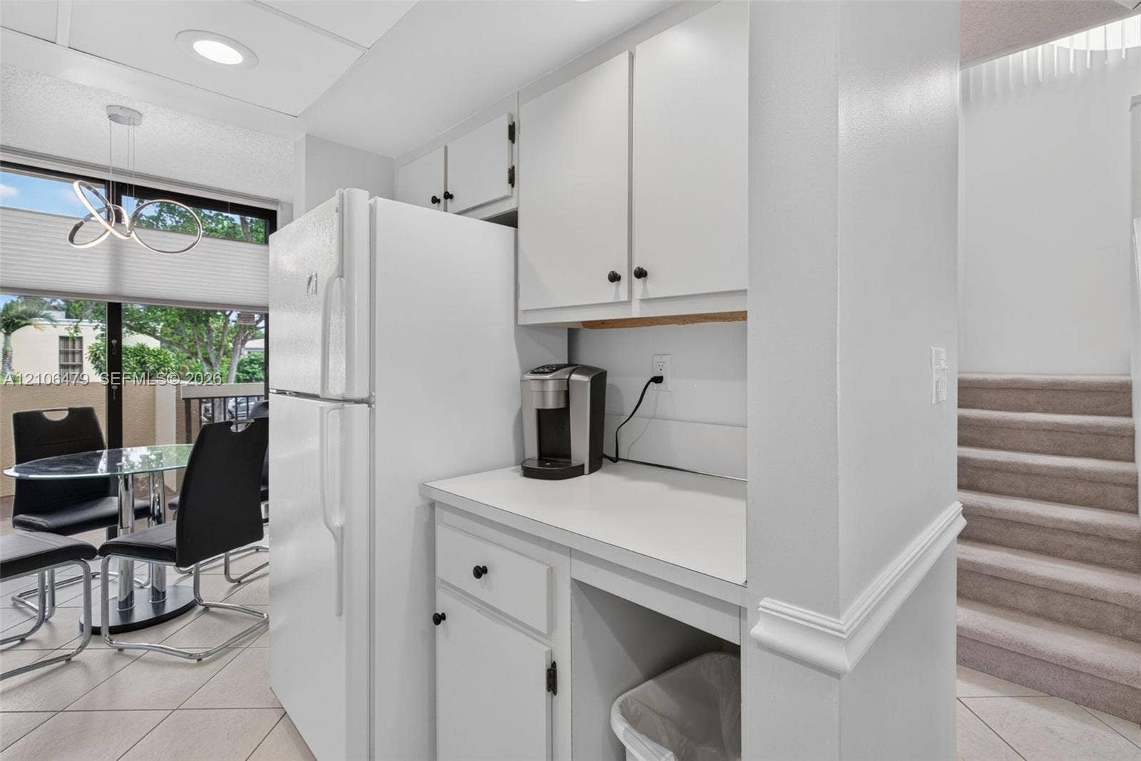 2800 SW 87th Avenue, #1113, Davie, FL 33328 Kitchen area featuring white cabinetry, solid-surface countertops, full-size refrigerator, recessed lighting, and tile flooring