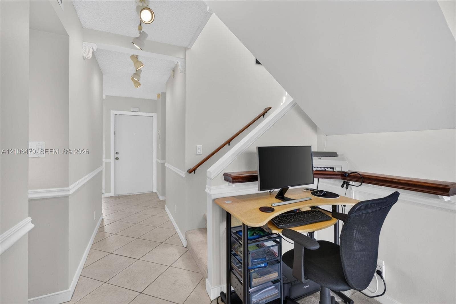 2800 SW 87th Avenue, #1113, Davie, FL 33328 Ceramic tile flooring, crown molding, track lighting, and a wooden handrail